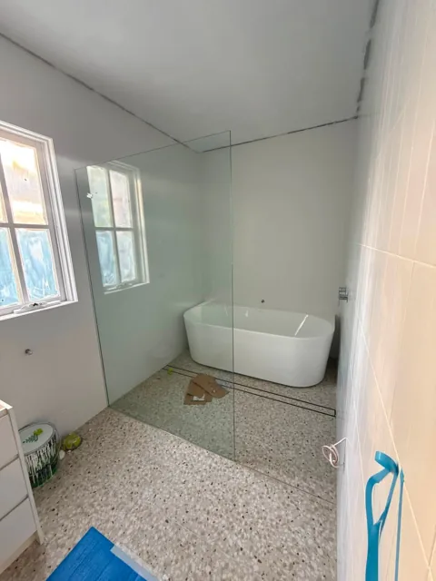Arched brass mirror and shower screens
