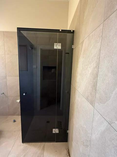 Black-framed and tinted shower screens
