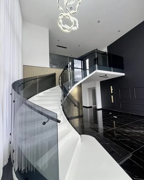 Spiral staircase glass with black handrail