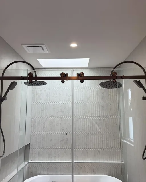 Twin shower with frameless slider